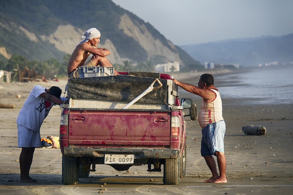 Images of the Canoa, Ecuador town, beach and locals men on red truck