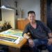 Terrell Thornhill at drafting table in his art studio