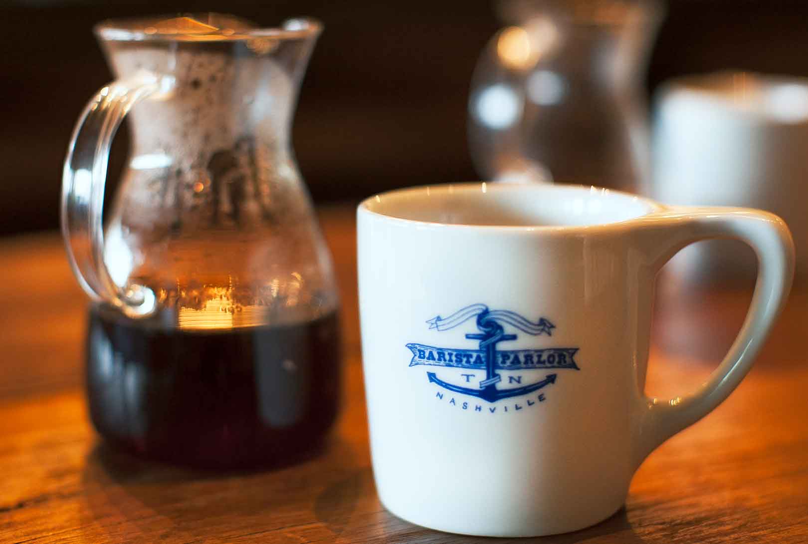 A unique coffee blend in a carafe with a mug at the Barista Parlor coffee shop