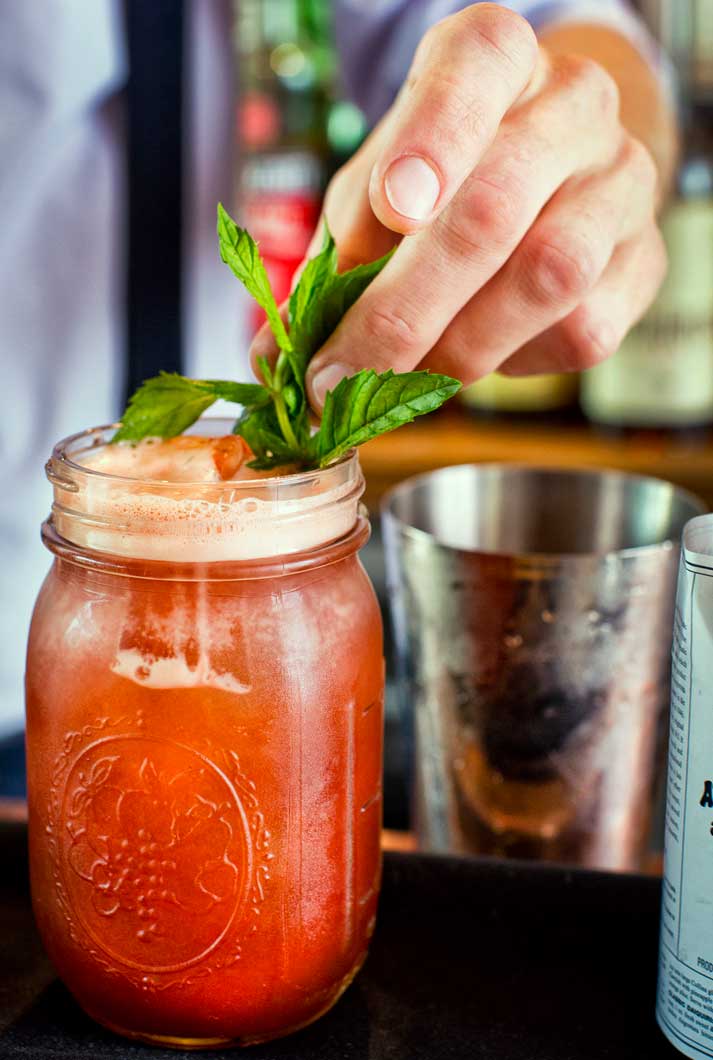 A Bloody Mary Craft Cocktail Garnished With Fresh Basil