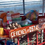 ceviche vendor cart attached to bike with freshly caught clams, oysters, shrimp, and other fixings on beach Manabi Ecuador