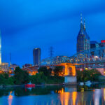 Downtown Nashville cityscape from across the Cumberland River with the pedestrian bridge