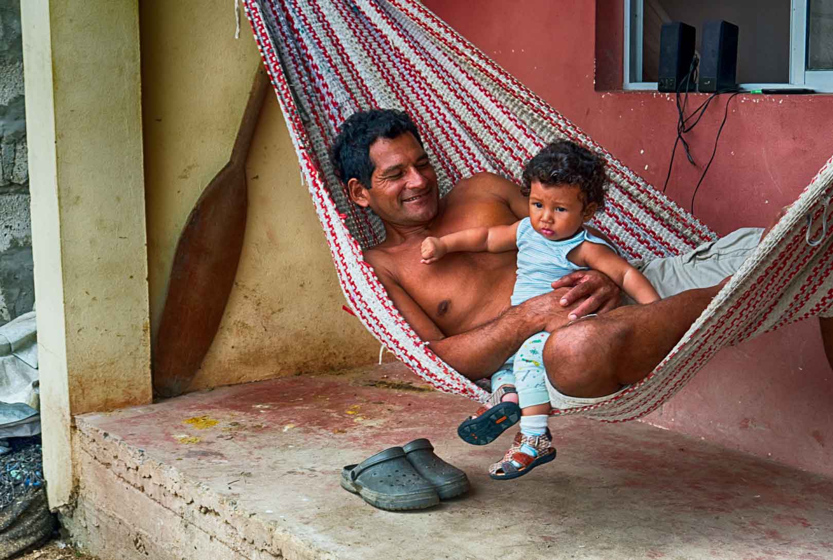 A Man And a Young Child In A Hammock In Ecuador
