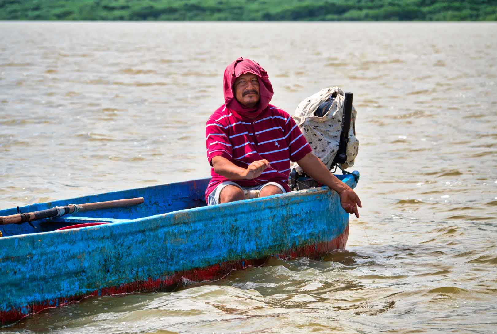 A Man Holding A Fishing Line By Hand On The Chone River