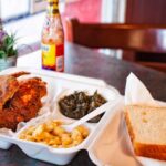 fried hot chicken dinner with white bread greens mac n cheese with hot sauce Sprite at Bolton's