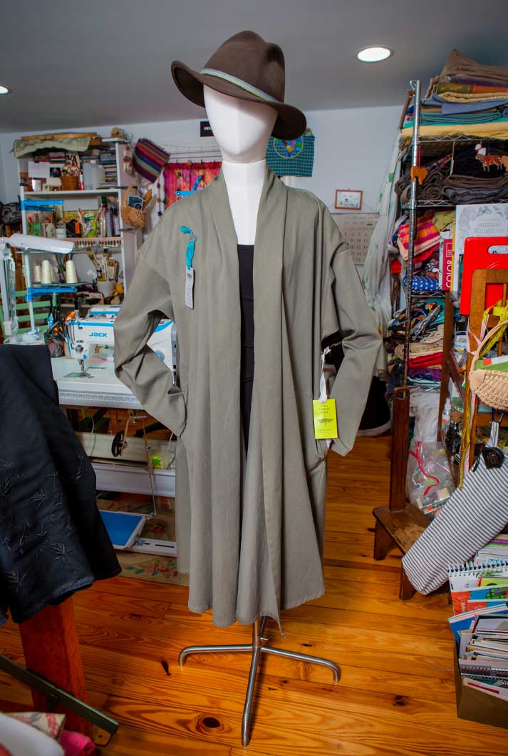 A hand-crafted custom olive green Capotto coat made from repurposed fabric by Lambert Clark