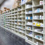 Inside an RX automated pharmacy limited distribution facility with shelves of medicine inventory