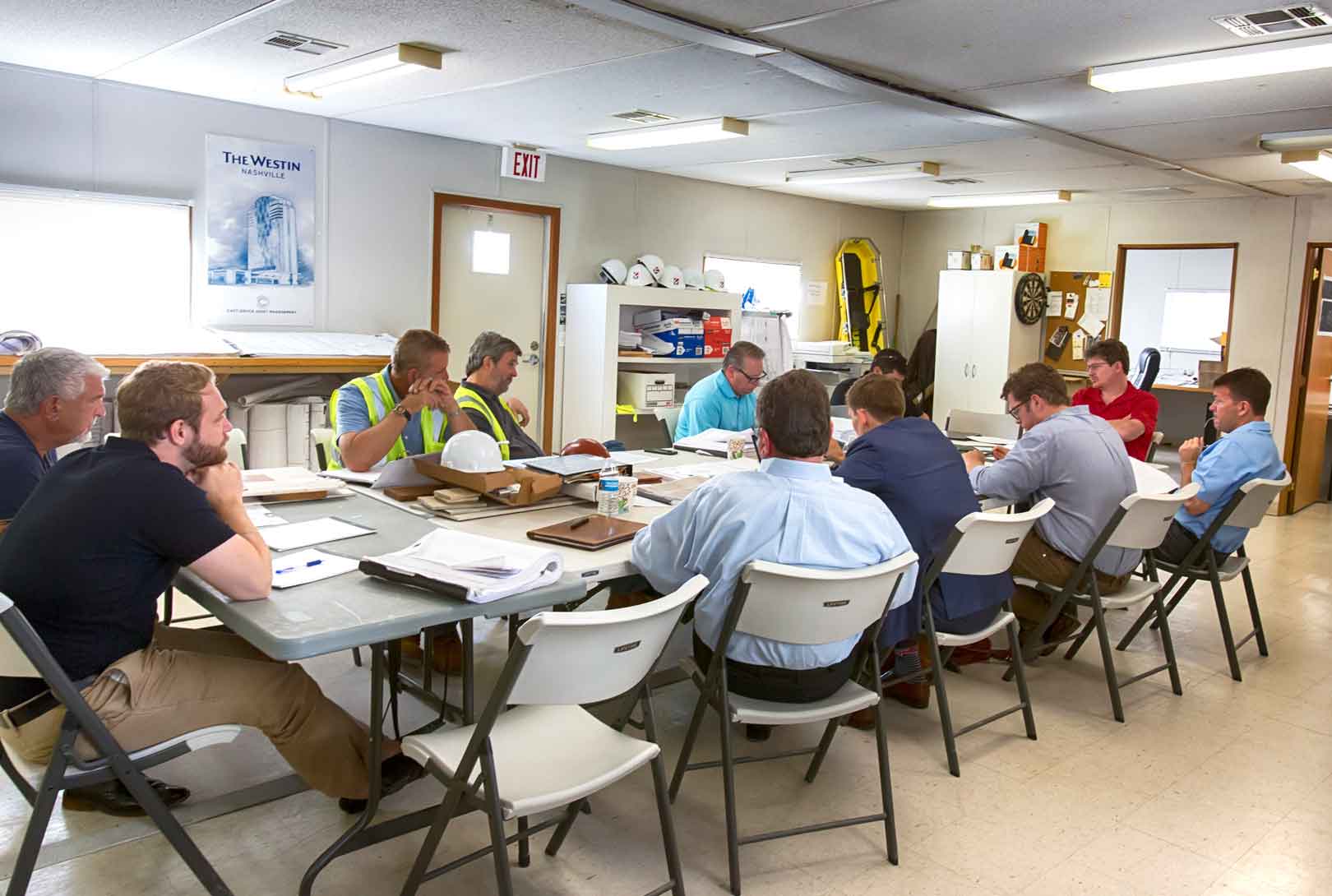 commercial contractors sitting in a portable at a table during meeting