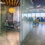 office space with modern design, glass walls and warm accent colors