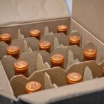 case of wine bottles with orange tops
