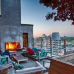 upstairs outdoor patio seating area near a stone fireplace that overlooks downtown Nashville
