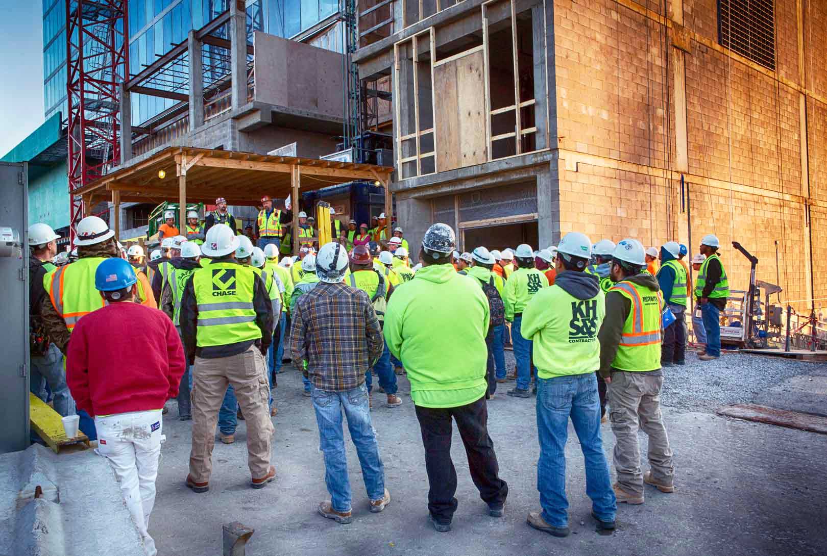 group meeting of hotel construction workers at construction site