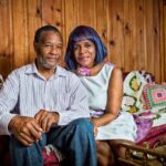 Patricia Lee with her husband Darnell Victor Jones sitting on their living room couch