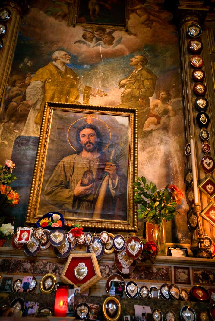 painting of Jesus holding image of Mary with other apostle paintings on the mantel of church in Rome