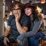John Oates sitting with his wife in their Nashville home
