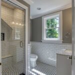 small remodeled bathroom with black and white tile at a home in Nashville on Linden