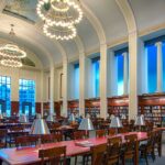 round painted ceiling chandeliers tables and chairs of grand reading room downtown library Nashville