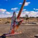 Tip of giant wooden graffiti arrow at Twin Arrows trading post building, Route 66