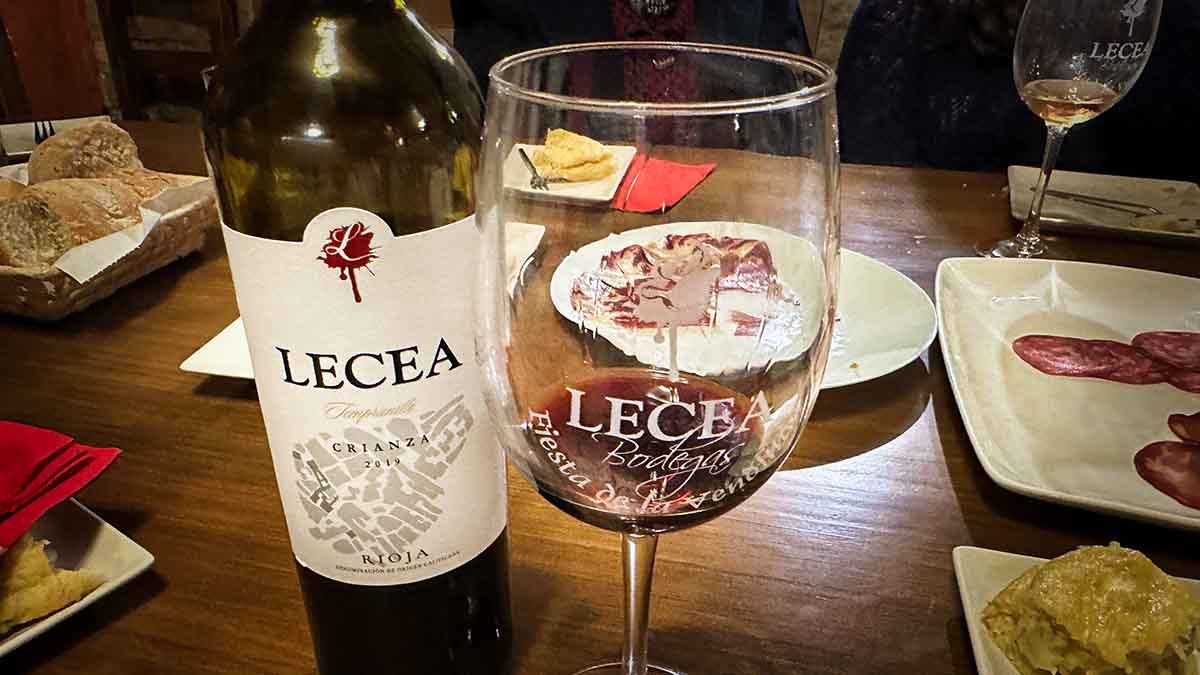 A bottle of Lecea wine with tapas at the Lecea vineyard tasting in Spain.