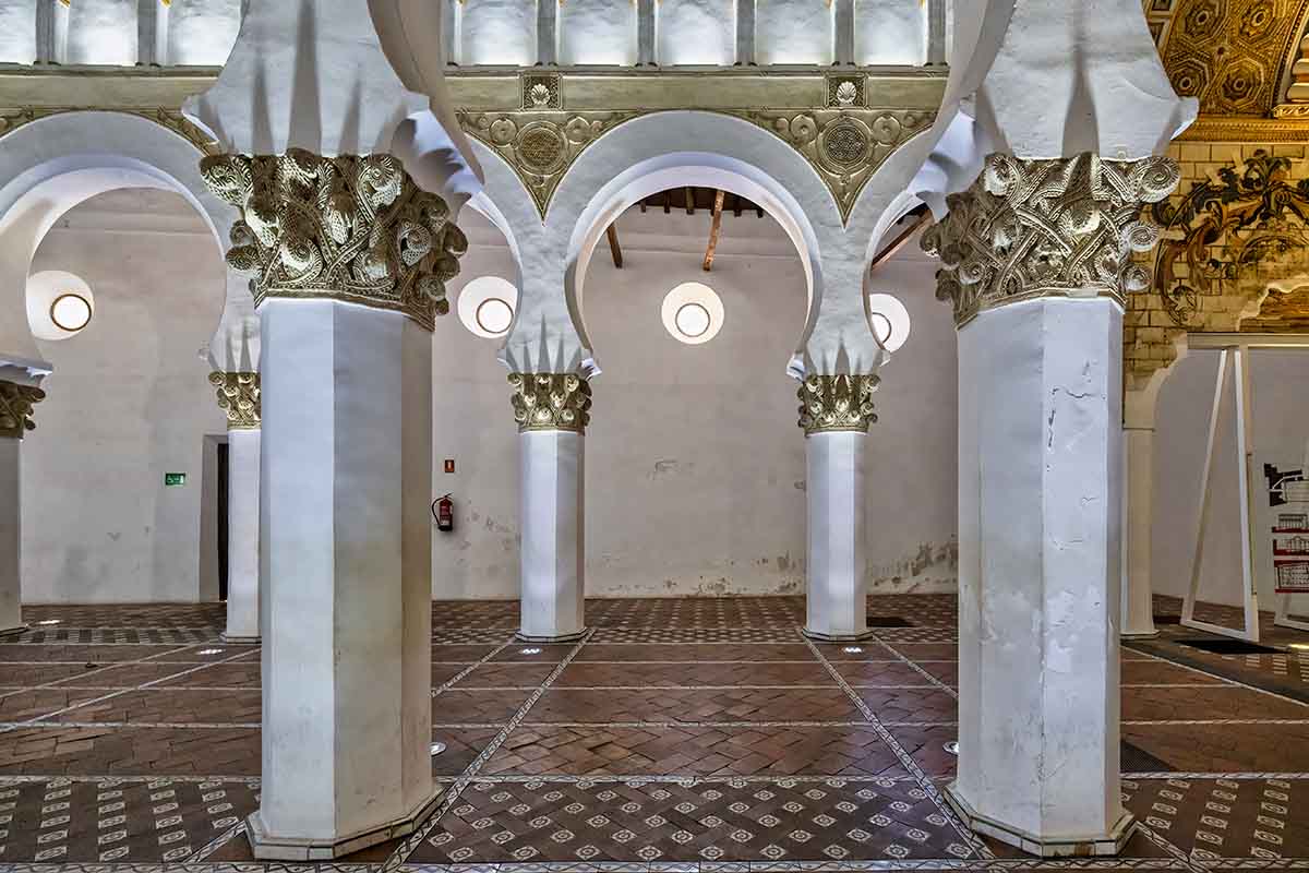 Inside the Santa Maria Blanca in Toledo, Spain, showcasing the white and gold columns.