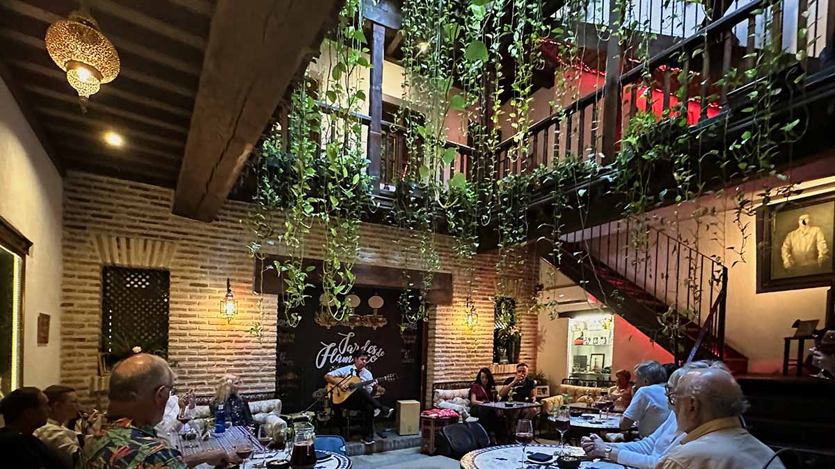 A Spanish flamenco guitarist playing for the guests' dining at the Casa Entre Dos Aguas in Toledo, Spain.