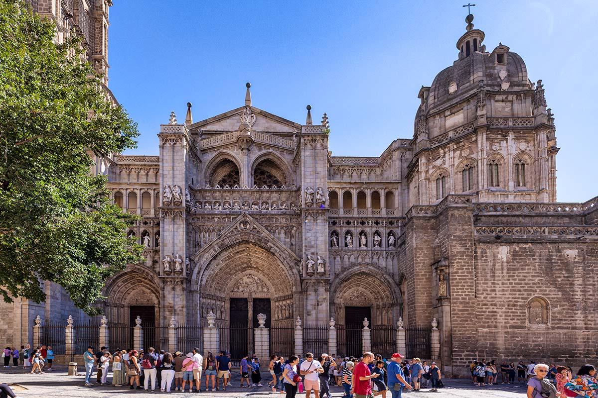 The Toledo Cathedral main entrance in Spain with tourists awaiting for it to open.