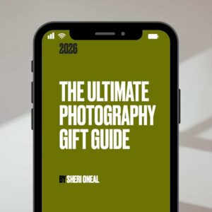 A smartphone displays a green screen with bold white text reading "Ultimate Photography Gift Guide For 2026 by Sheri Oneal" and "2026" at the top.