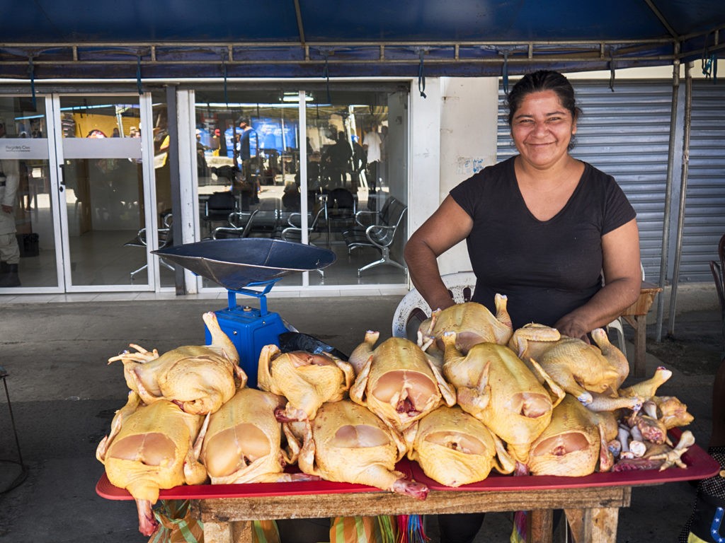 Chicken vendor in the semi open air market in downtown Bahia de Caraquez, Ecuador