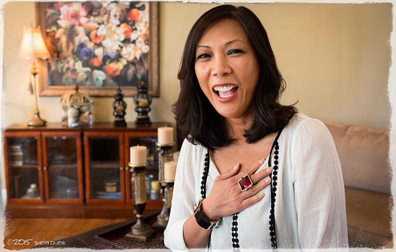 A portrait of Loan Hillsten in her living room as she shares her story as a 1975 Vietnamese Refugee coming to America for blog series Fabulous Women Over 40