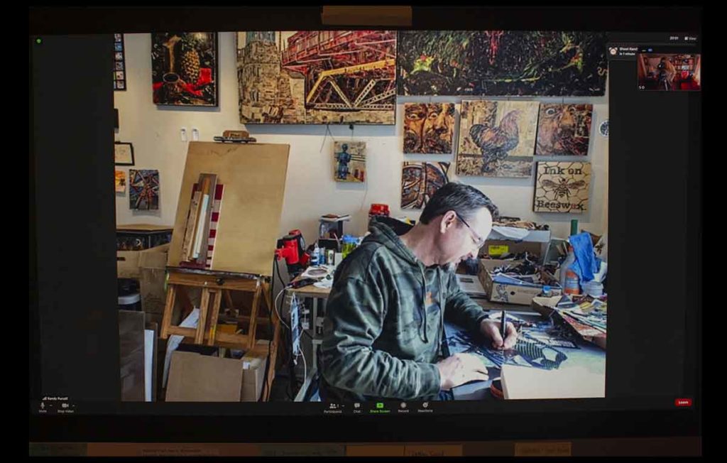 artist in studio at desk
